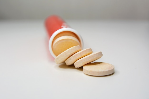 Effervescent vitamin C tablets on a white surface