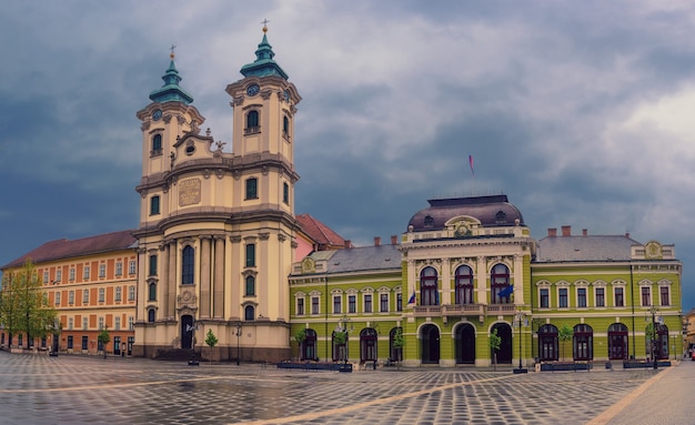 Eger main square in Hungary, Europe with dark moody sky and catholic cathedral. Travel outdoor european background