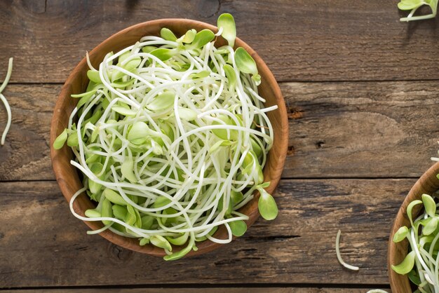 Egetable young sunflower sprouts on wood 