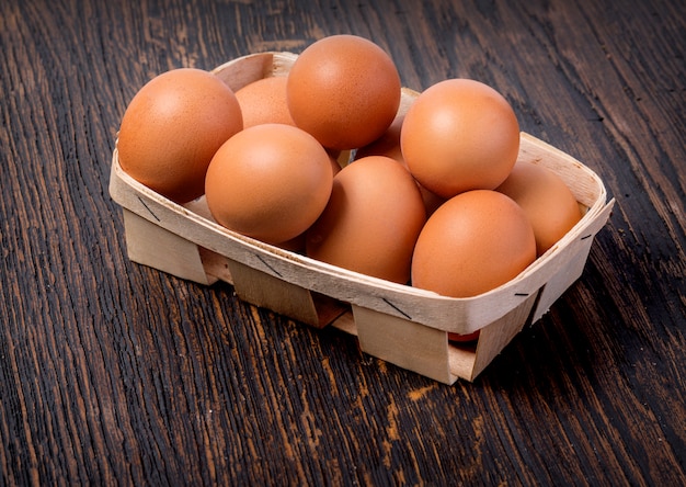 Egg in a basket on wooden table