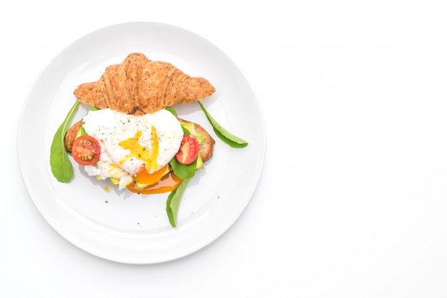 Egg benedict with avocado, tomatoes and salad - healthy or vegan food style