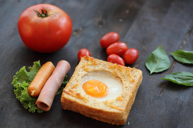 Egg in bread on wooden background