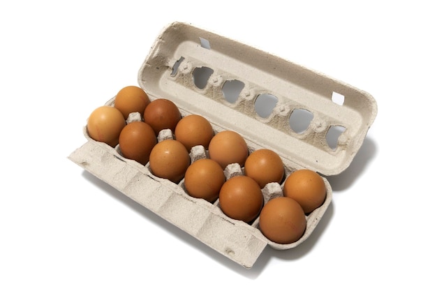 An egg carton container with a dozen brown eggsIsolated on a white backgroundEco products concept