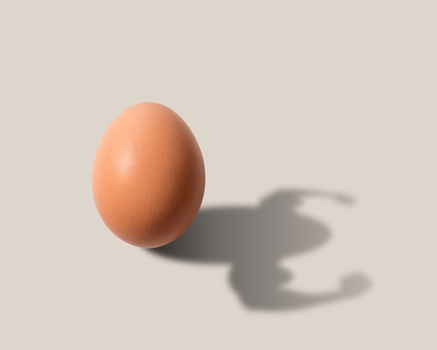 The egg casts a shadow in the form of a bodybuilder.