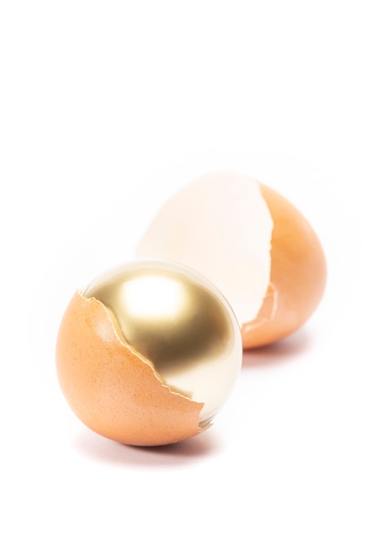 An egg cracked and has golden sphere inside