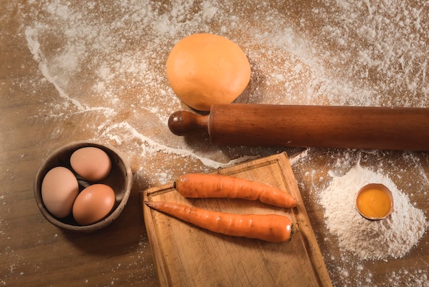 Egg dough for noodles with ingredients on the table traditional italian cuisine