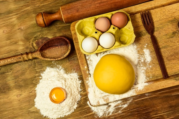 Egg dough for noodles with ingredients on the table