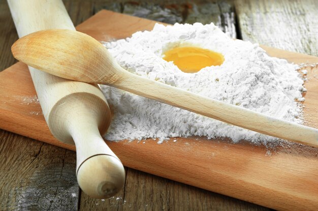 Egg in flour on a wooden board