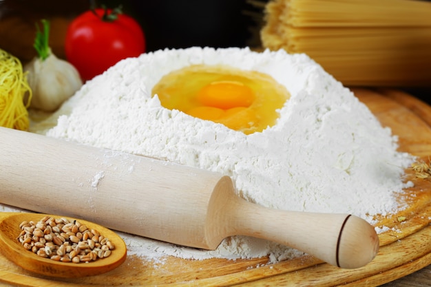 Egg in flour on a wooden board