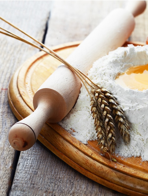 Egg in flour on a wooden board