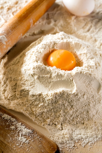 Egg and flour on a wooden table