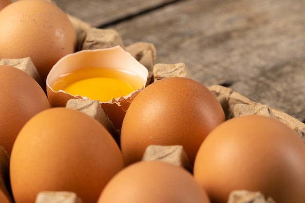 Egg is half broken on wooden table