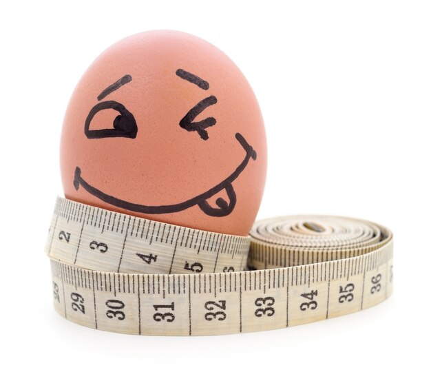 Egg and measuring tape on a white background.