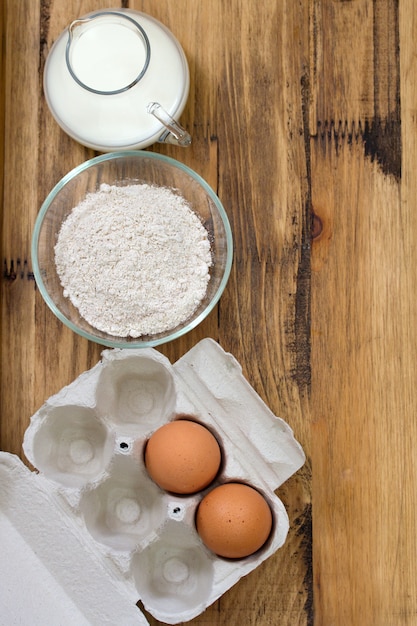 Egg and milk on brown wooden surface