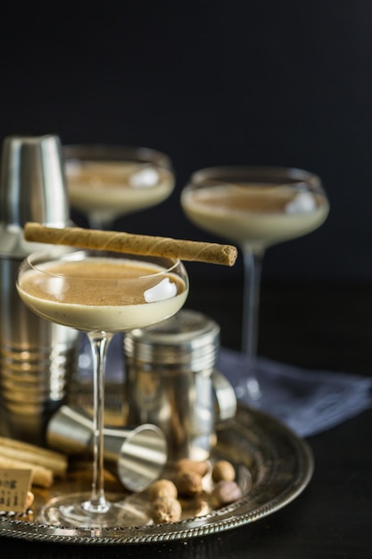 Egg nog cocktail in tall glasses on the tray at the minibar.