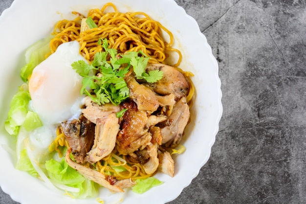 Egg noodles served dry with roasted honey chicken and soft boiled eggs (onsen tamago eggs)