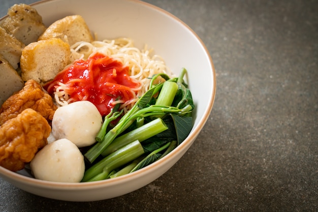 egg noodles with fish balls and shrimp balls in pink sauce, Yen Ta Four or Yen Ta Fo - Asian food style