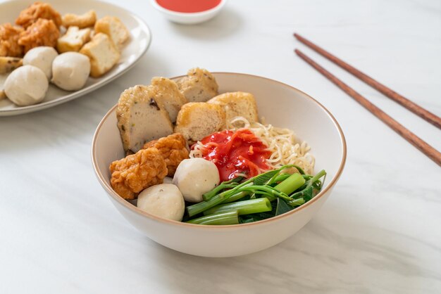 egg noodles with fish balls and shrimp balls in pink sauce, Yen Ta Four or Yen Ta Fo - Asian food style