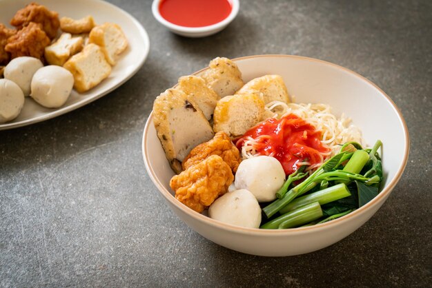 egg noodles with fish balls and shrimp balls in pink sauce, Yen Ta Four or Yen Ta Fo - Asian food style