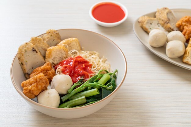 egg noodles with fish balls and shrimp balls in pink sauce, Yen Ta Four or Yen Ta Fo - Asian food style