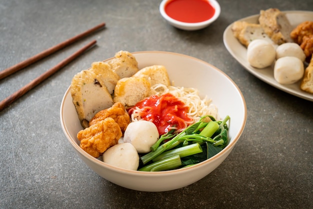 Egg noodles with fish balls and shrimp balls in pink sauce Yen Ta Four or Yen Ta Fo