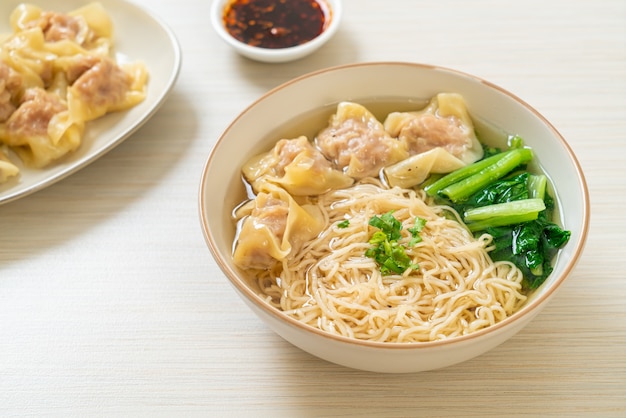 egg noodles with pork wonton soup or pork dumplings soup and vegetable - Asian food style