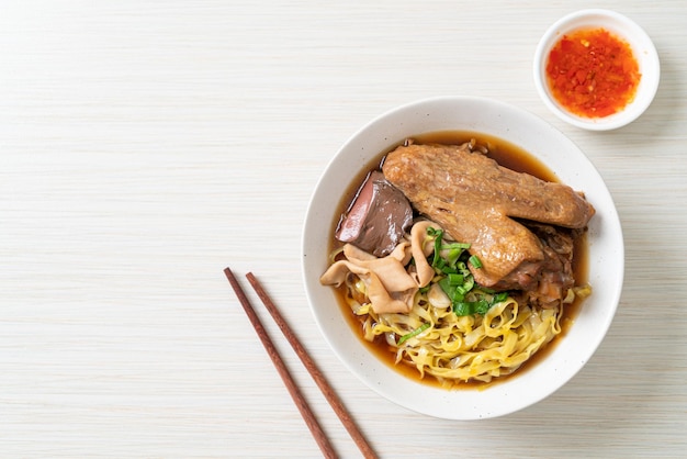 Egg noodles with stewed and braised duck in brown soup