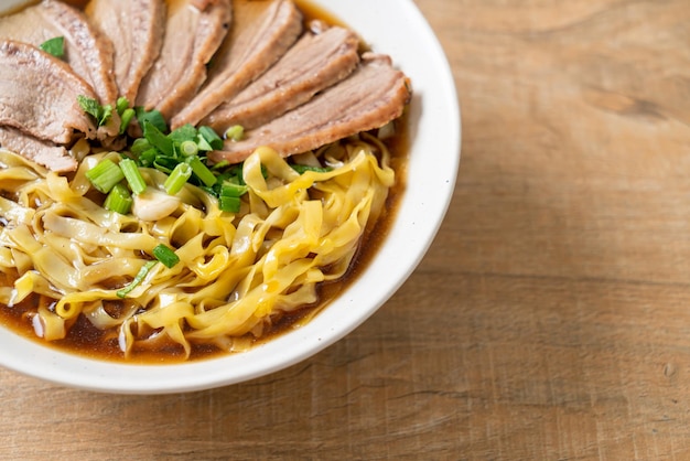 egg noodles with stewed duck in brown soup - Asian food style