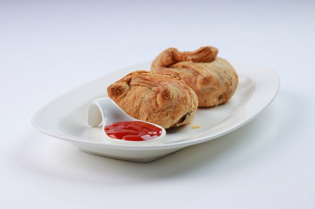 Egg Puff pastry filled with spicy and tasty egg masala and placed on a white tableware