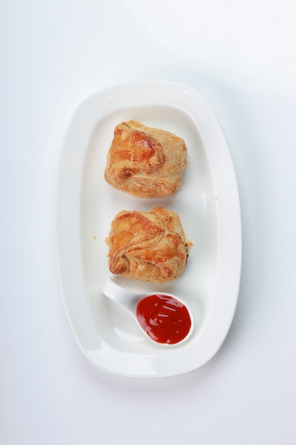 Egg Puff pastry filled with spicy and tasty egg masala and placed on a white tableware