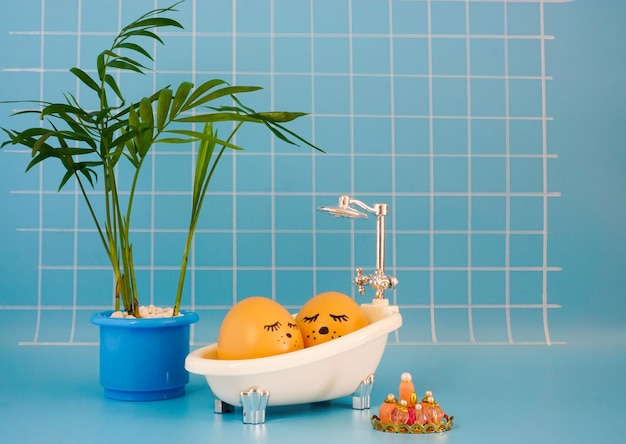 Egg takes a bath in a blue bathroom with a palm tree