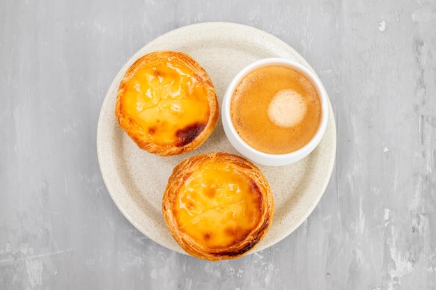 Egg tart traditional portuguese dessert pastel de nata and cup of coffee