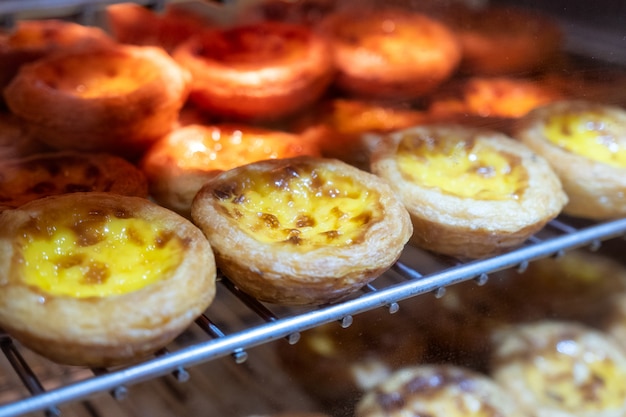 Egg tart with custard cream baking on grille. Sweet dessert traditional in asian