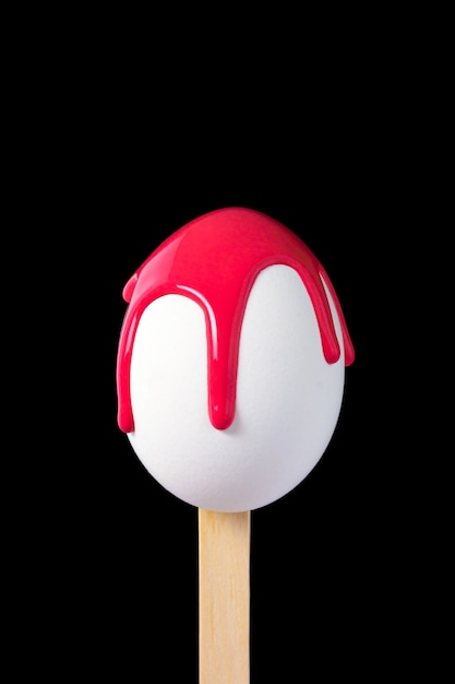 Egg on a wooden stick drenched colors