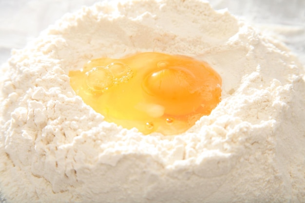 Egg yolk on white flour for dough