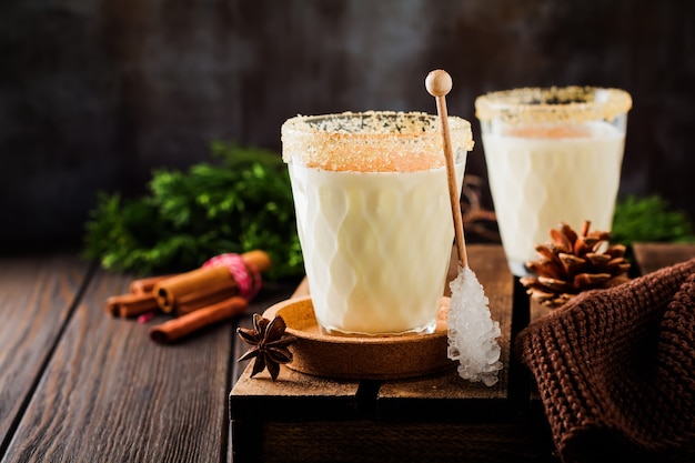 Eggnog Traditional Christmas drink milkshake with cinnamon