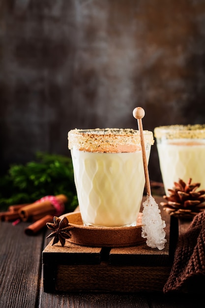 Eggnog Traditional Christmas drink milkshake with cinnamon