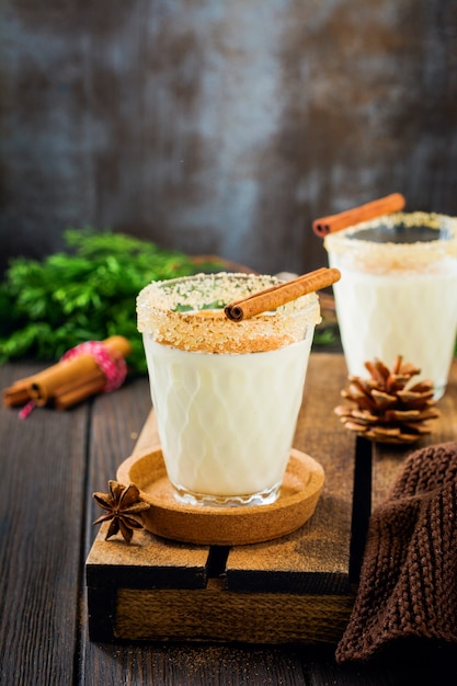 Eggnog Traditional Christmas drink milkshake with cinnamon