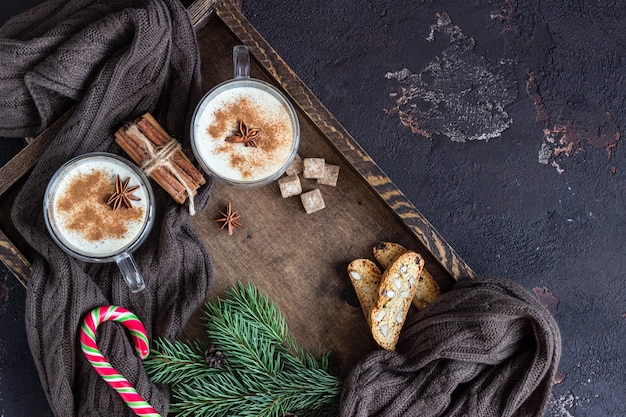 Eggnog with cinnamon, served in two glass mugs