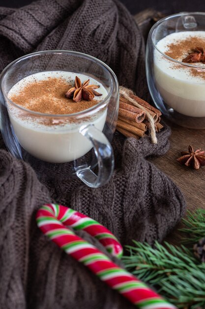 Eggnog with cinnamon, served in two glass mugs