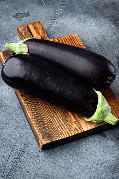 Eggplant aubergine organic ripe whole vegetables on gray stone background