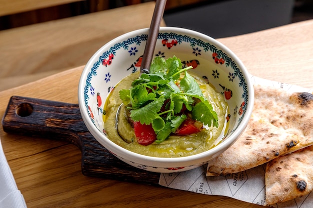 Eggplant caviar garnished with fresh herbs and pastries