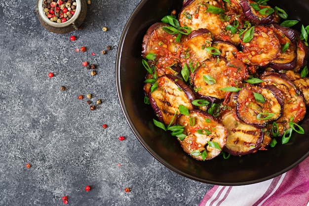 Eggplant grilled with tomato sauce, garlic, cilantro and mint