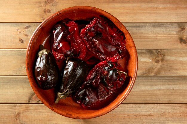 Eggplant and peppers roasted on clay vessel