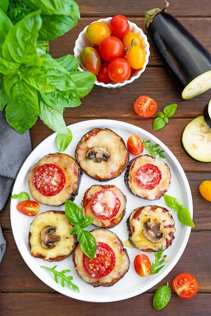 Eggplant pizza with tomatoes sauce mozzarella mushrooms and basil Vegetarian dish Selective focus