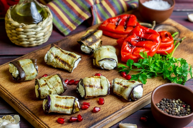 Eggplant rolls with cheese on a wooden background. Healthy eating.