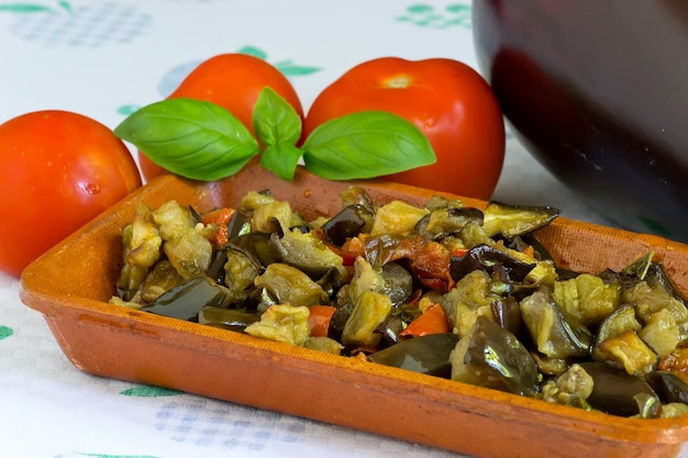 Photo eggplants in terrine surrouded by ingredients