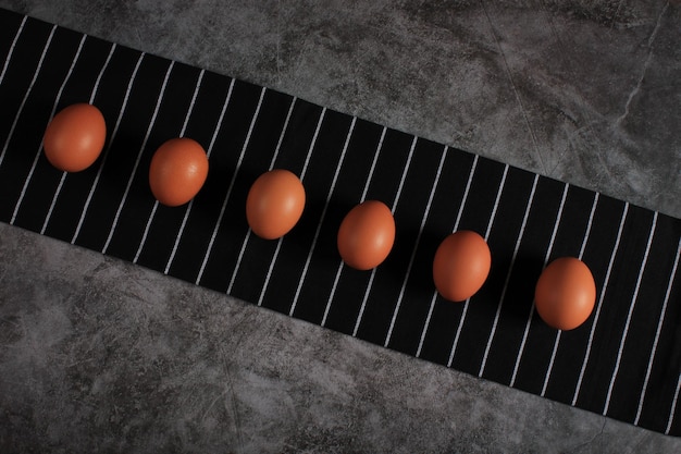 Eggs against black striped kitchen towel