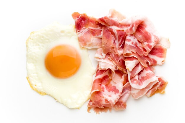 Eggs and bacon on the isolated surface.