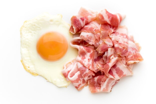 Eggs and baconon on the isolated surface.